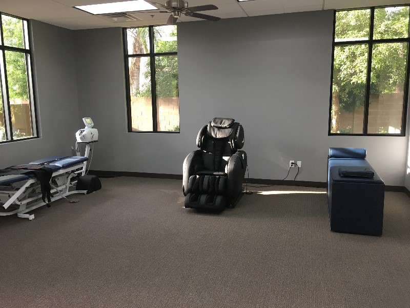 Therapy room with massage chair and table