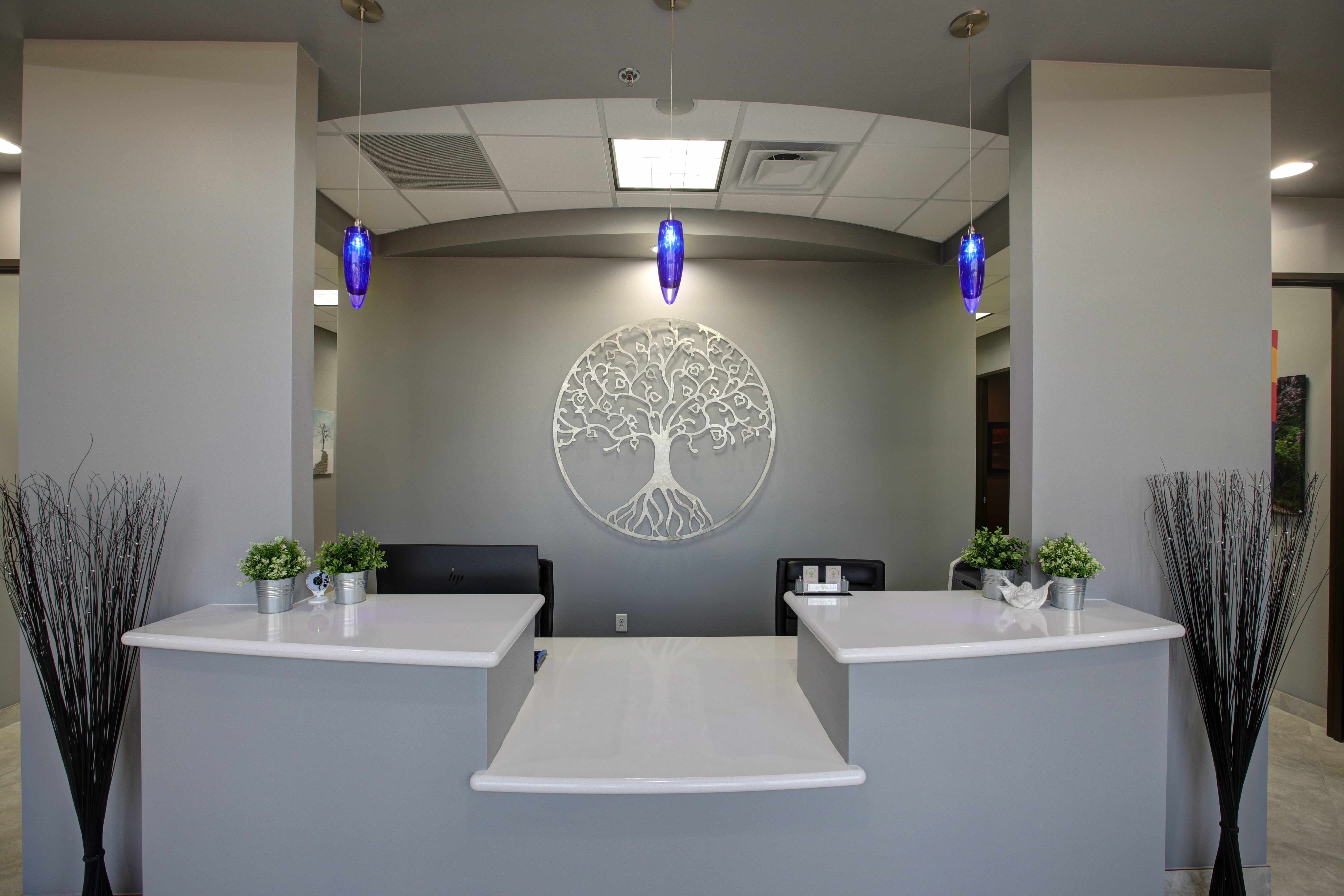 Reception desk with tree-of-life artwork